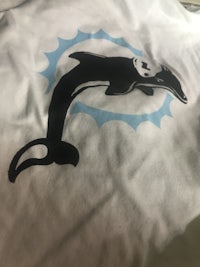 a white t - shirt with an orca on it