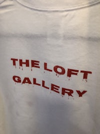 a white t - shirt that says the loft gallery
