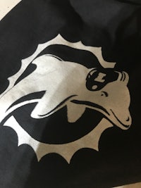 the miami dolphins logo on a black t - shirt