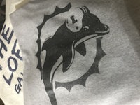 the miami dolphins logo on a grey t - shirt
