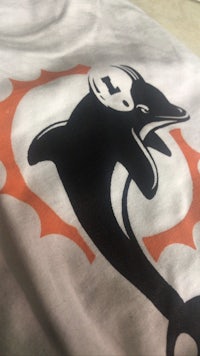 the miami dolphins logo on a white t - shirt