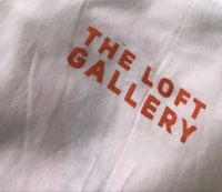 the loft gallery logo on a white shirt